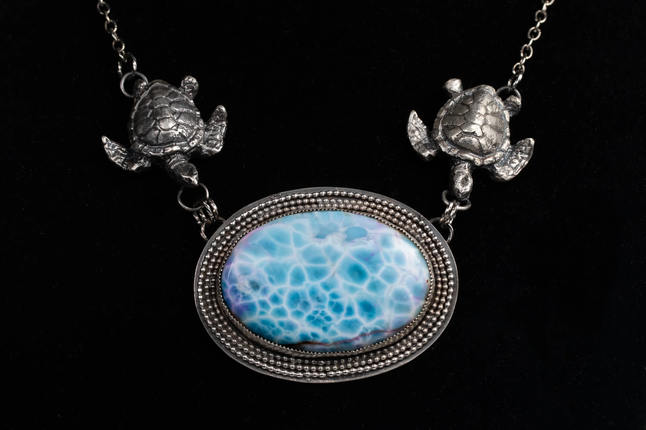 Handcrafted Larimar Turtle Pendant by Michelle Grigore Handcrafted sterling silver pendant featuring carved larimar turtles and gemstone accents.